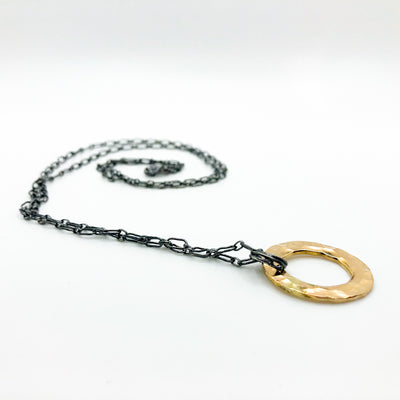 side angle view of Oxidized Sterling & 14k Gold Filled Ball Pein Circle Necklace by Judie Raiford