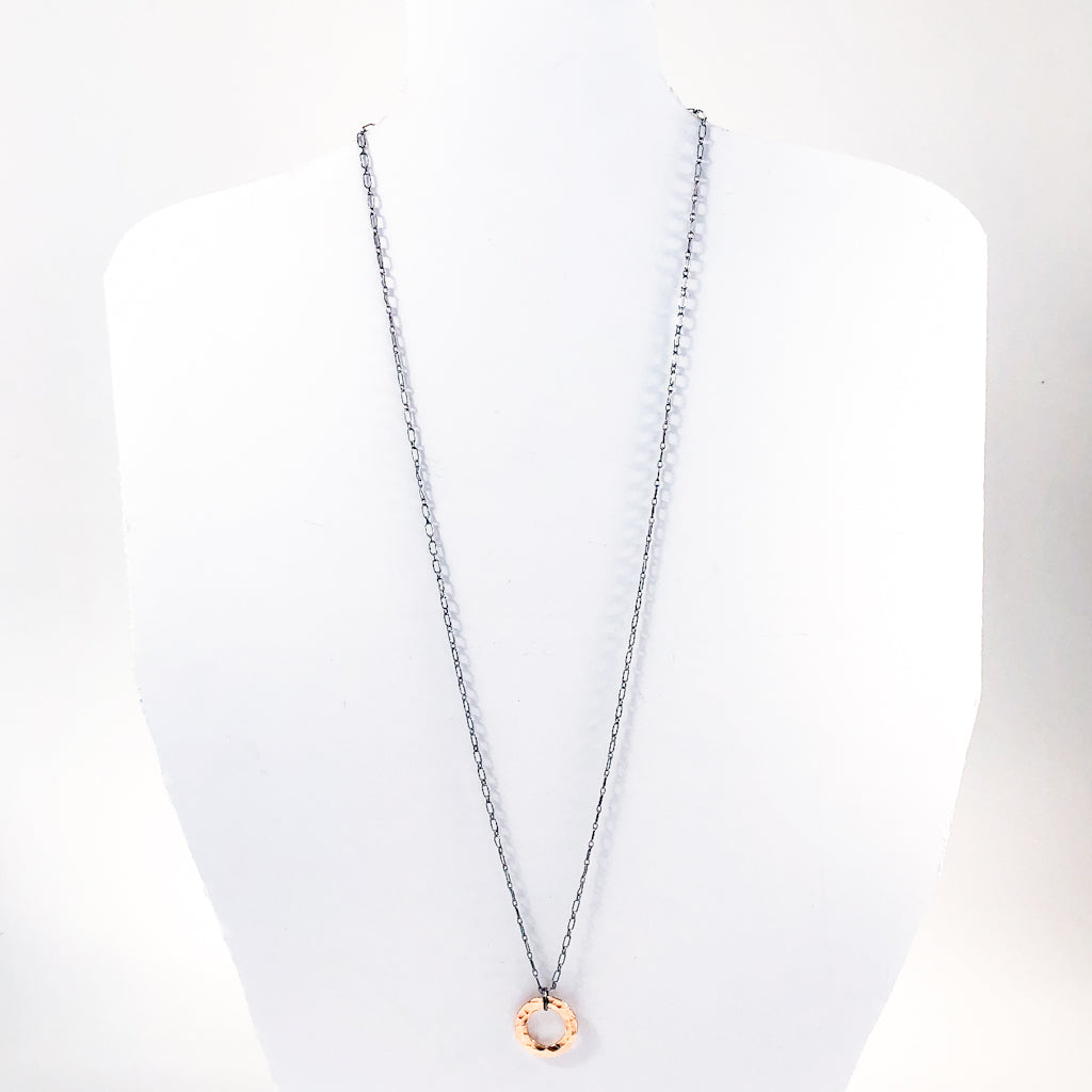 Oxidized Sterling & 14k Gold Filled Ball Pein Circle Necklace by Judie Raiford hanging on white mannequin bust
