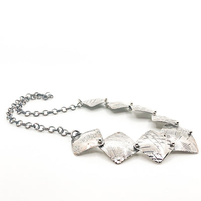 side angle view of Oxidized Sterling Traveling Squares Necklace by Judie Raiford