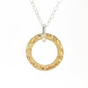 detail of pendant view of Sterling and 14k Gold Filled Ball Pein Hammered Circle Pendant Necklace by Judie Raiford