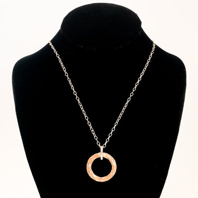 Sterling and 14k Gold Filled Ball Pein Hammered Circle Pendant Necklace by Judie Raiford displayed on black mannequin bust