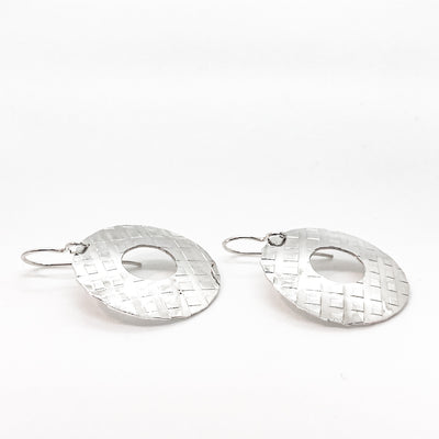 side angle view of sterling silver Square Hammered Olive Earrings by Judie Raiford