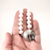 Sterling Cupcake Necklace with White Baroque Pearls by Judie Raiford held in hand