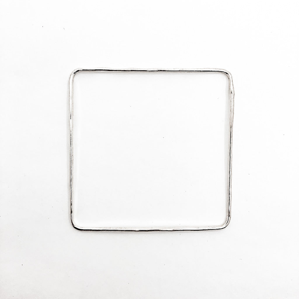 over top view of Sterling Hammered Square Bangle by Judie Raiford