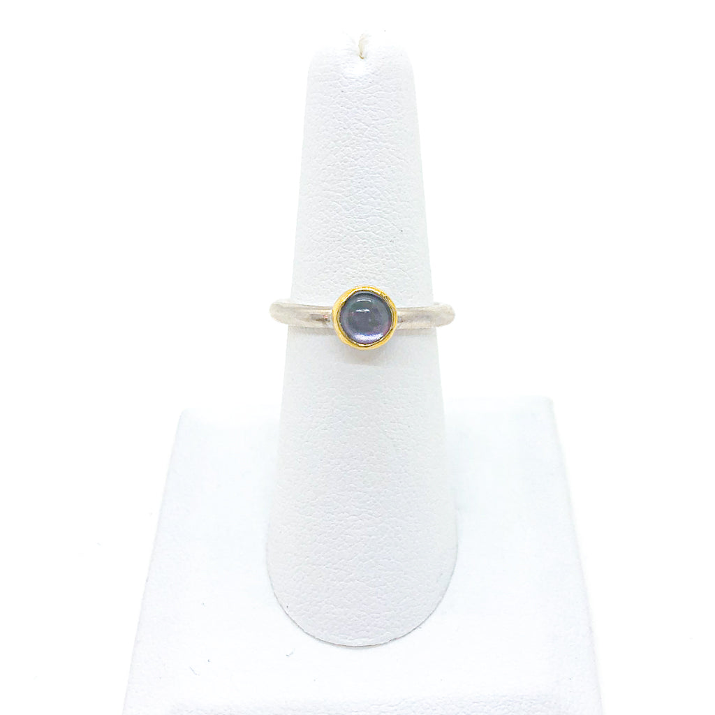 size 6.5 Round Iolite Ring by Judie Raiford on white ring display stand