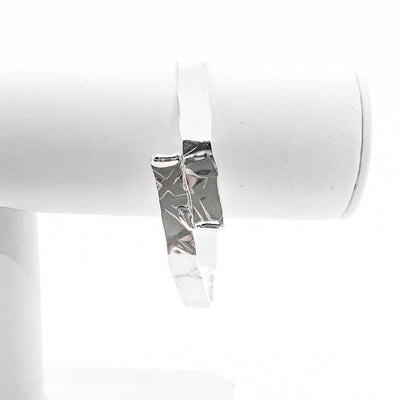 Sterling Heavy Octagon Bangle by Judie Raiford on white jewelry display stand