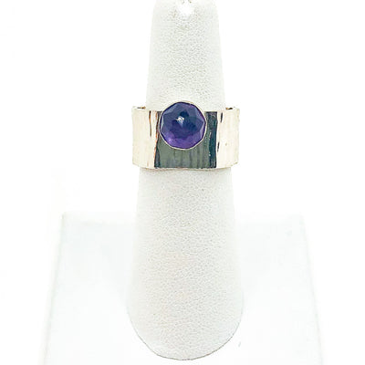 size 6.5 Sterling Cross Pein Hammered Ring with Amethyst by Judie Raiford on white ring display stand