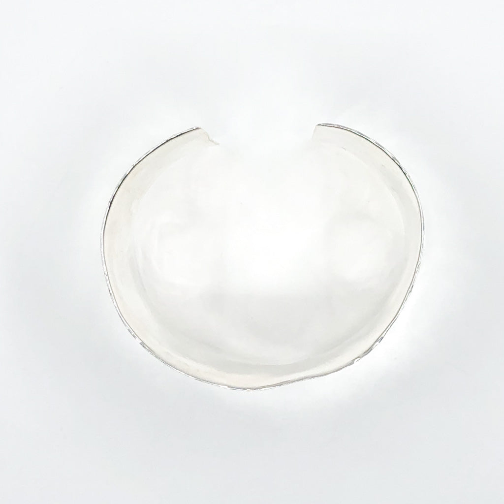 over top view of Sterling 1.5" Ball Pein Anticlastic Cuff by Judie Raiford