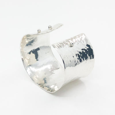 side angle view of Sterling 1.5" Ball Pein Anticlastic Cuff by Judie Raiford