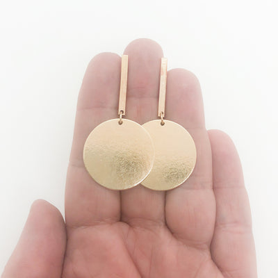 14k Gold Filled Skipper Dot Earrings by Judie Raiford held in hand
