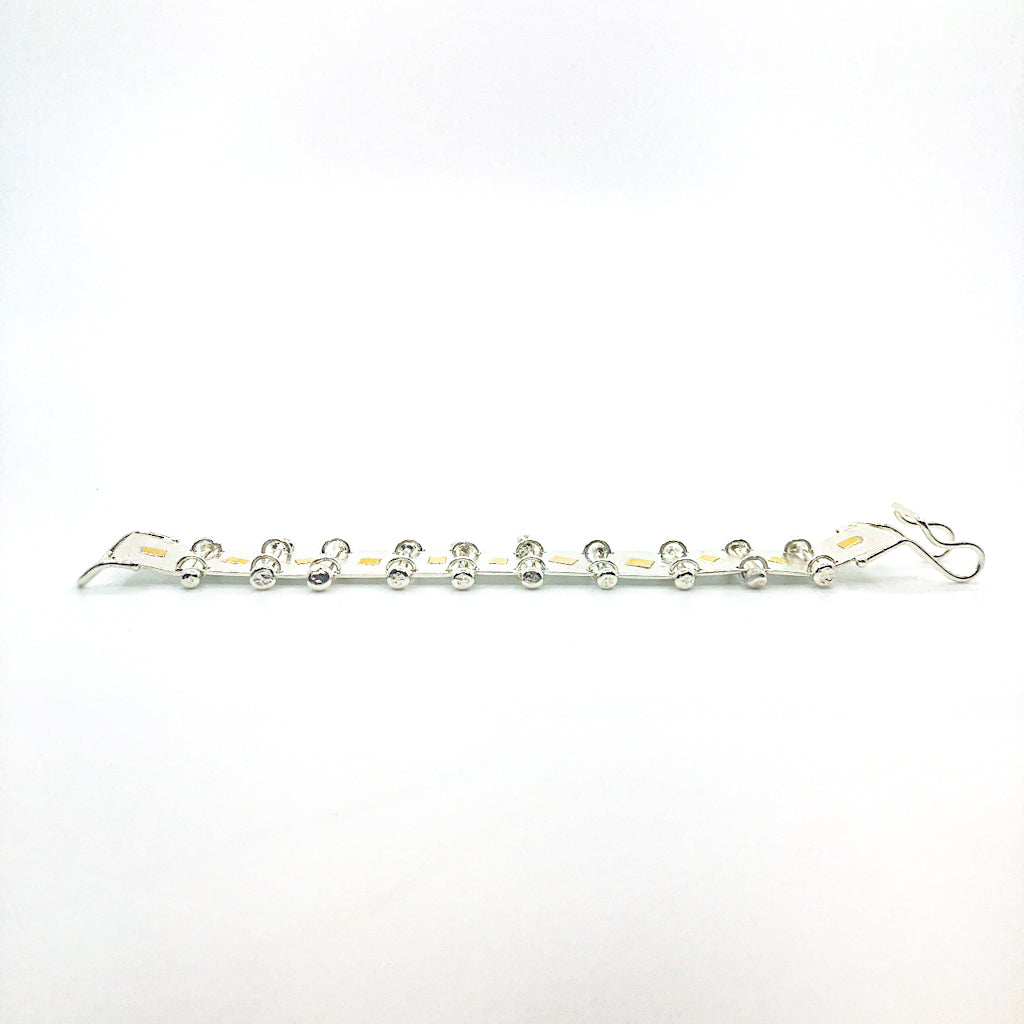 side angle view of Sterling and 22k Singer Bracelet by Judie Raiford