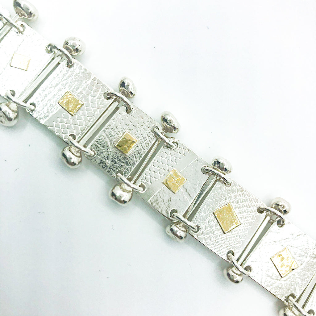 detail view of Sterling and 22k Singer Bracelet by Judie Raiford