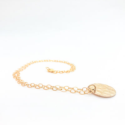 side angle view of 14k Gold Filled Ball Pein Mini Flat Circle Disc Necklace by Judie Raiford