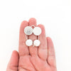 Sterling Silver Comet Earrings with White Coin Pearl by Judie Raiford held in hand
