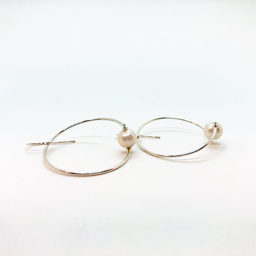 side angle view of Sterling Twisted Hoop Pearl Earrings by Judie Raiford