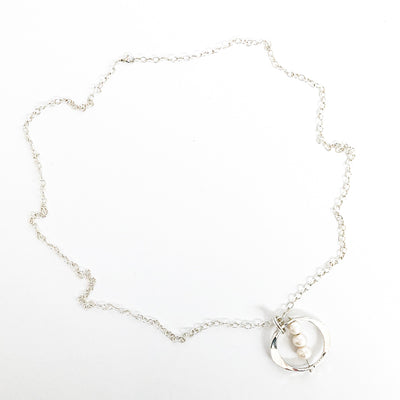 flat lay view of Large Naught Necklace with 3 White Pearls by Judie Raiford
