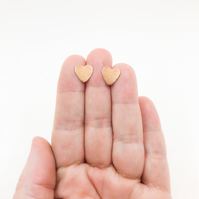 14k Gold Filled Paper Textured Heart Stud Earrings by Judie Raiford held in hand