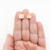 14k Gold Filled Mom's Hammered Square Stud Earrings by Judie Raiford held in hand