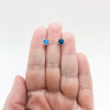 6mm Abalone Cabochon Stud Earrings by Judie Raiford held in hand