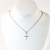 Sterling Tiny Cross Necklace by Judie Raiford on white mannequin bust