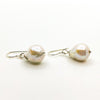 side angle view of Small White Baroque Pearl Earrings by Judie Raiford