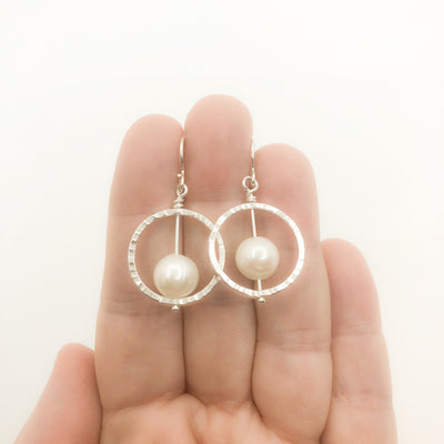 Sterling Not Naught Round Pearl Earrings with White Pearls by Judie Raiford held in hand