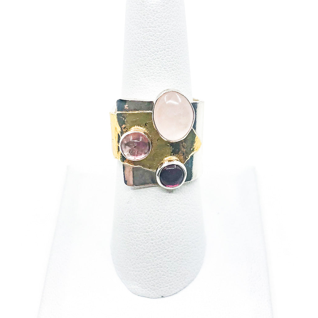 size 9.5 Sterling & 24k Crotch Hugger Ring with Pink Quartz, Pink Tourmaline, and Garnet by Judie Raiford on white ring display stand