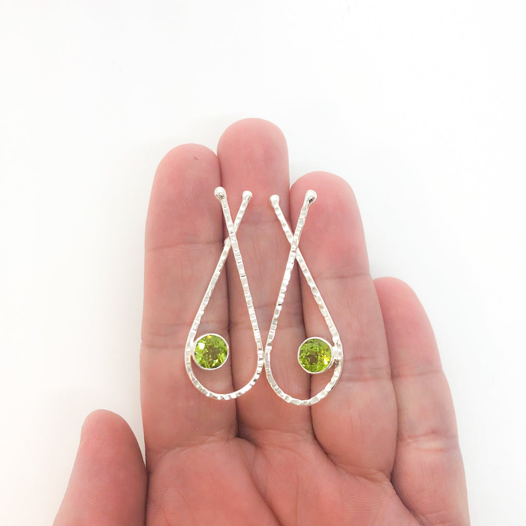 Sterling Jody Looped Earrings with Peridot by Judie Raiford held in hand