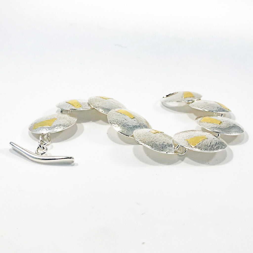 side angle view of Sterling and 24K Bark Bracelet by Judie Raiford