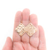 14k Rose Gold Ball Pein Square Earrings by Judie Raiford held in hand