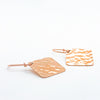 side angle flat lay 14k Rose Gold Ball Pein Square Earrings by Judie Raiford