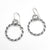 flat lay view of polished and oxidized sterling silver Double Twist Hoop Earrings by Judie Raiford