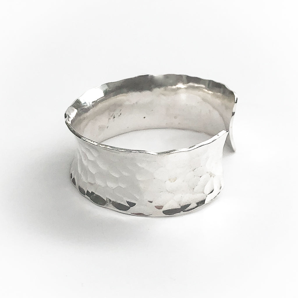 side view of Sterling Anticlastic Ball Pein Cuff by Judie Raiford