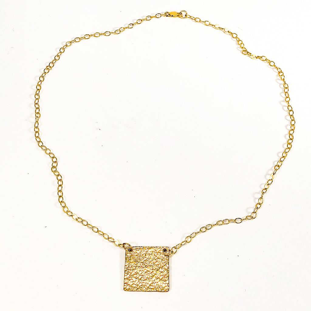 flat lay view of 14k Gold Filled Mom's Hammer Square Necklace by Judie Raiford