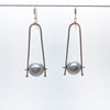 Short Tic Toc Earrings with Gray Pearls by Judie Raiford hanging on a wire