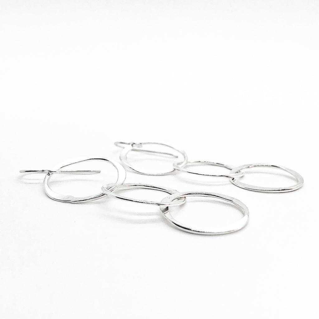 side angle view of sterling silver Hammered Triple Circle Earrings by Judie Raiford