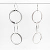 sterling silver Hammered Triple Circle Earrings by Judie Raiford hanging on a wire