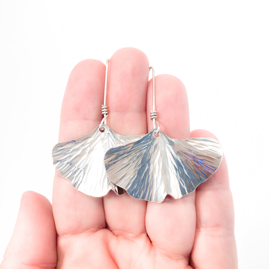 Large Sterling Ginkgo Earrings by Judie Raiford held in hand