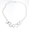 flat lay of Hammered Sterling Silver 7 Heart Necklace by Judie Raiford