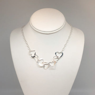 Hammered Sterling Silver 7 Heart Necklace by Judie Raiford on mannequin