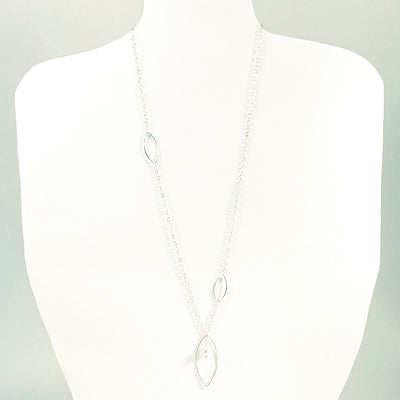 Long Leaf Lariat Necklace with White Pearl by Judie Raiford on white mannequin display bust