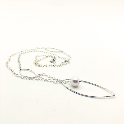 side angle view of Long Leaf Lariat Necklace with White Pearl by Judie Raiford