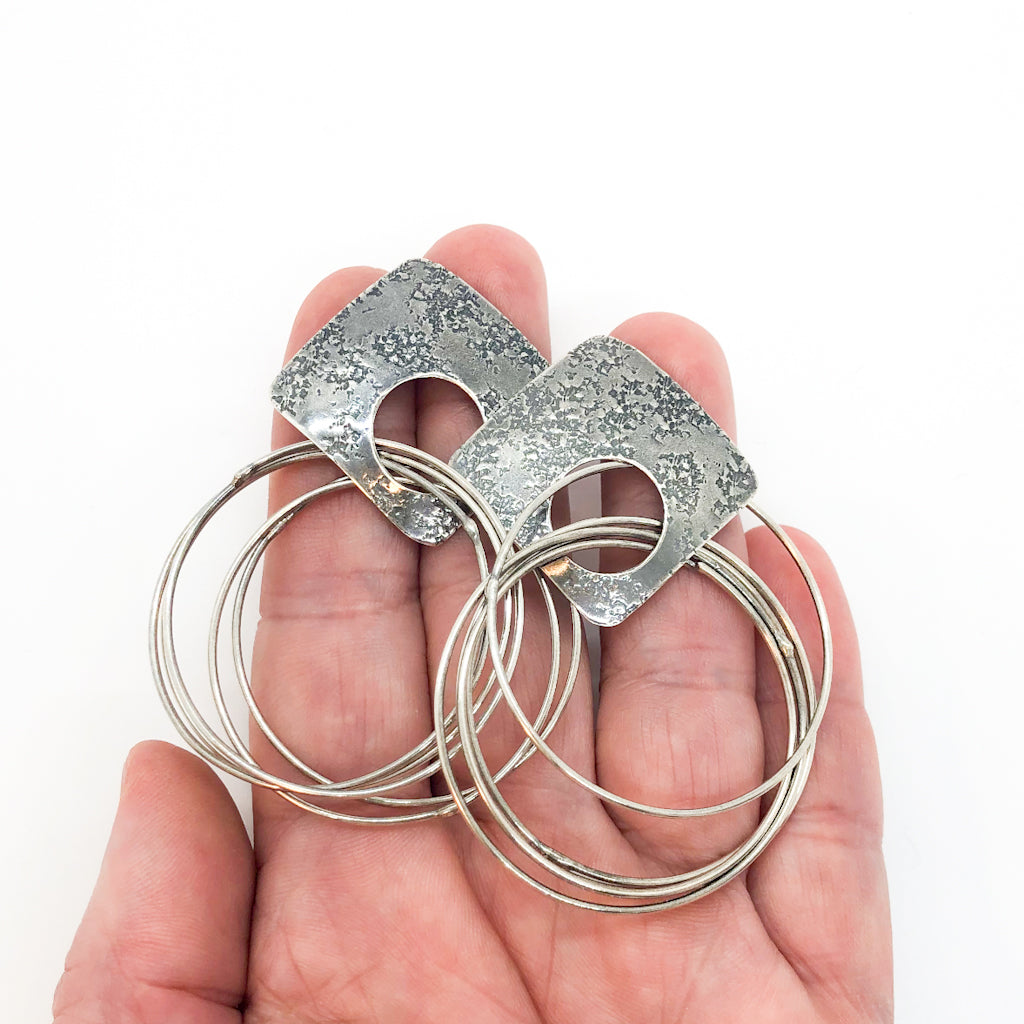 Oxidized Sterling Square Top Slinky Post Earrings by Judie Raiford held in hand