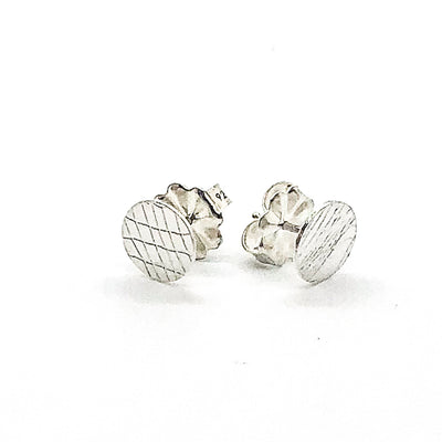 side angle view of Sterling Textured Circle Stud Earrings by Judie Raiford