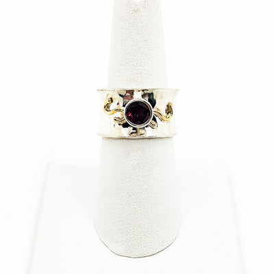size 6 Sterling and 14k Anticlastic Ring with Rhodolite Garnet by Judie Raiford on white ring display stand