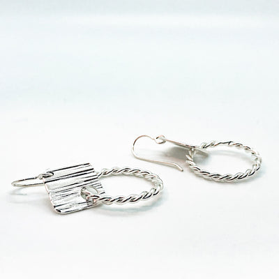 side angle view of sterling silver Boiler Twister Hoop Earrings by Judie Raiford