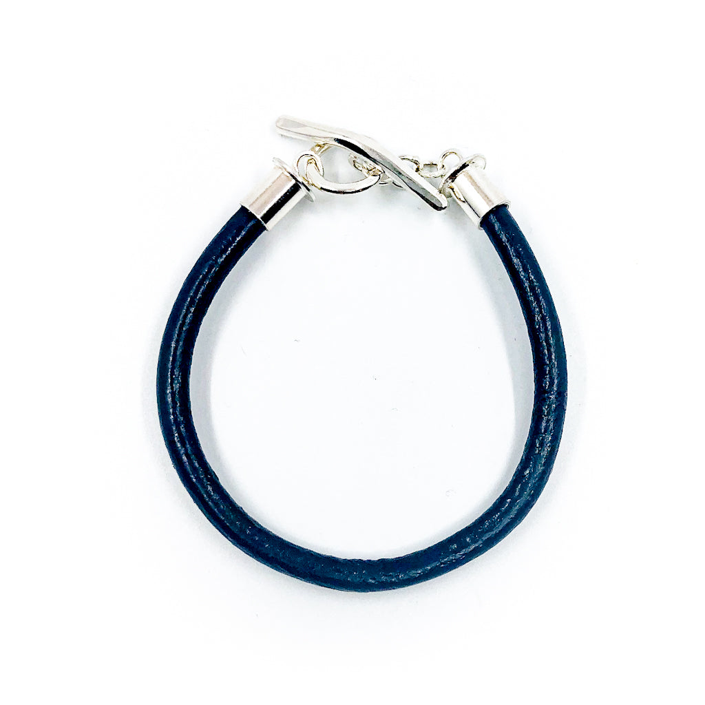 over top view of Men's Sterling and Black Leather Bracelet by Judie Raiford