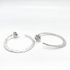 side angle view of sterling silver medium Forged Hoops by Judie Raiford