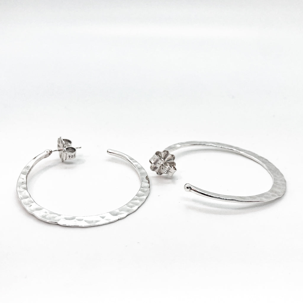 side angle view of sterling silver medium Forged Hoops by Judie Raiford