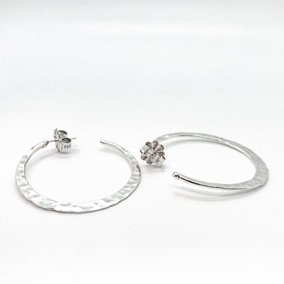 side angle view of sterling silver medium Forged Hoops by Judie Raiford